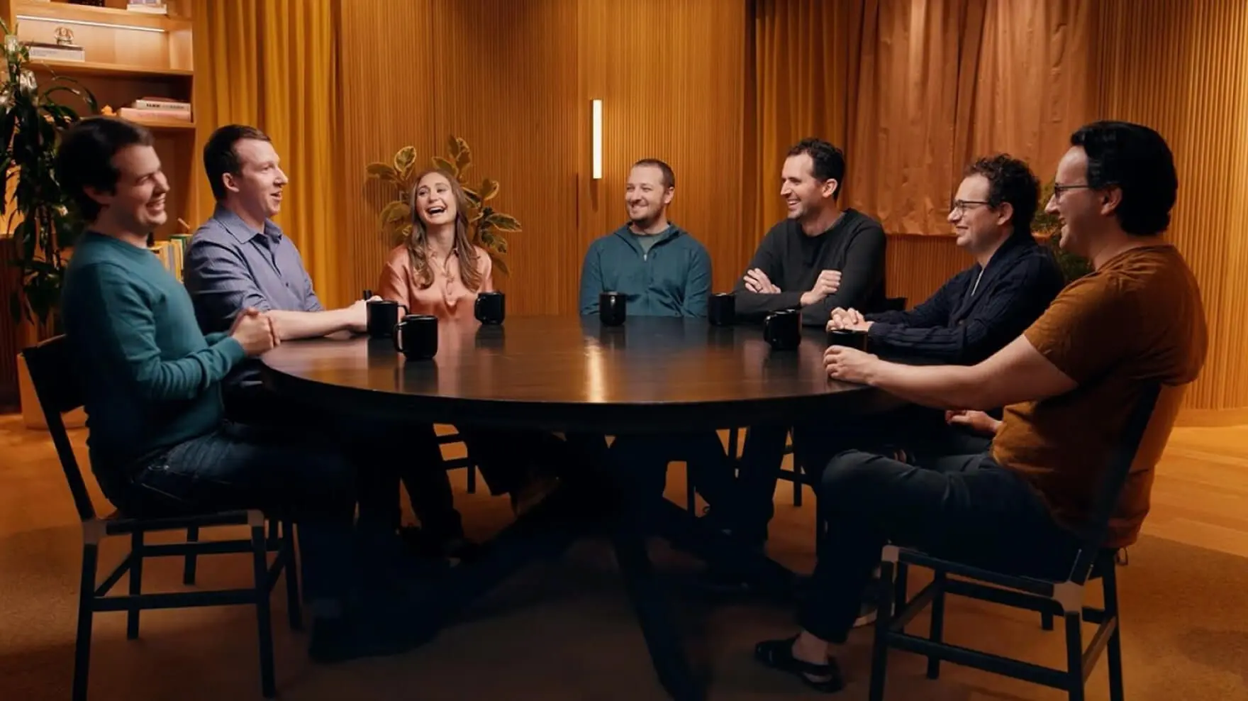 Anthropic’s careers-page video still showing its team around a table; this is a company source image, not a photograph of the future fellows.