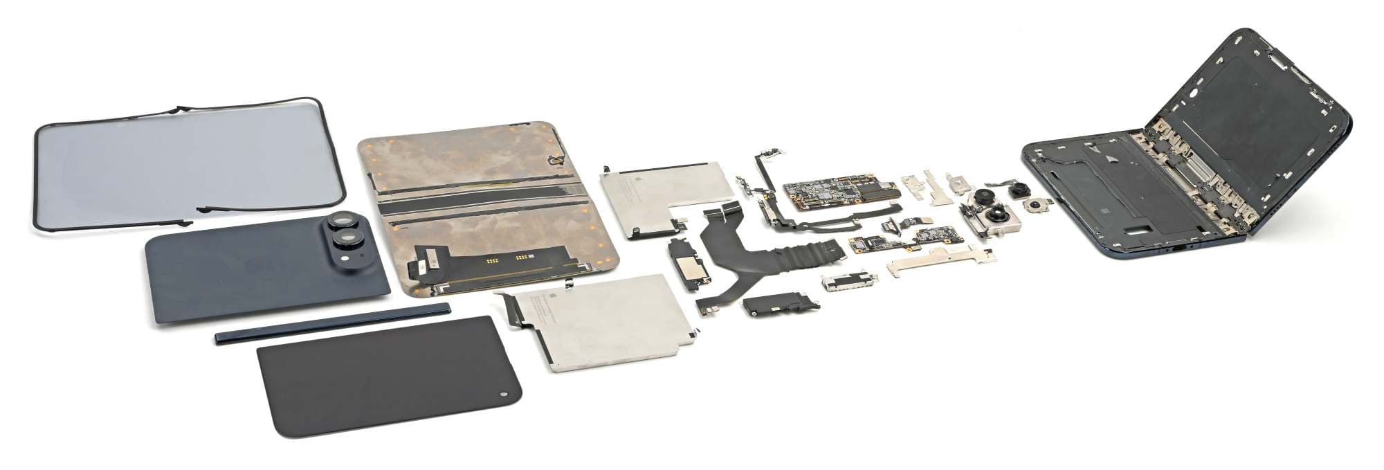 iFixit’s original photograph shows an iPhone Duo disassembled into its displays, batteries, boards and hinge assembly. This is a real teardown photograph, not a generated image or a confirmed diagnosis of every screen failure.